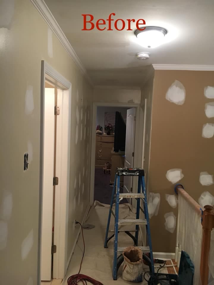 Hallway with drywall patching and prep work underway before touch-up painting.