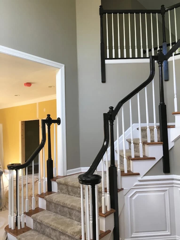 Freshly painted staircase with crisp trim work in a finished home interior.